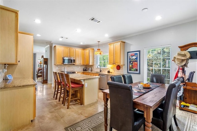 dining room featuring crown molding, recessed lighting, and light tile patterned floors