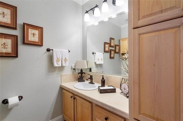 bathroom with ornamental molding and vanity
