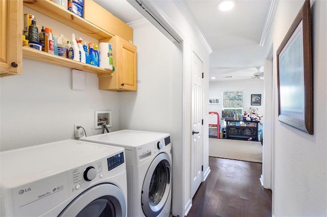 washroom featuring washing machine and clothes dryer, crown molding, cabinet space, ceiling fan, and dark wood-type flooring