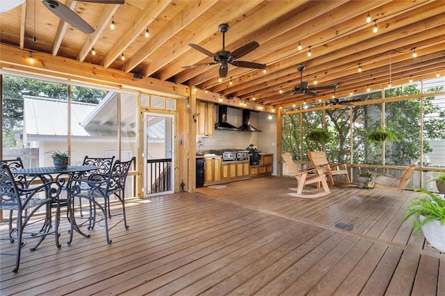 wooden deck featuring outdoor dining area, ceiling fan, and a sink