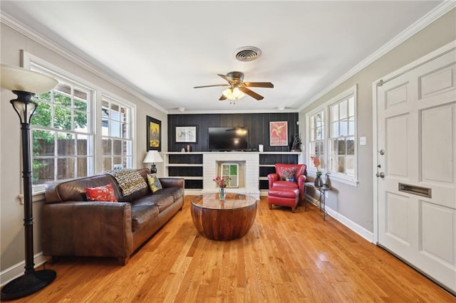 5139 Pratt Dr, New Orleans, LA 70122 - living room featuring crown molding, healthy amount of natural light, wood finished floors, a ceiling fan, and baseboards