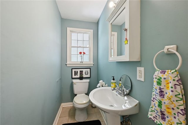 5139 Pratt Dr, New Orleans, LA 70122 - half bath with tile patterned floors, toilet, a sink, and baseboards
