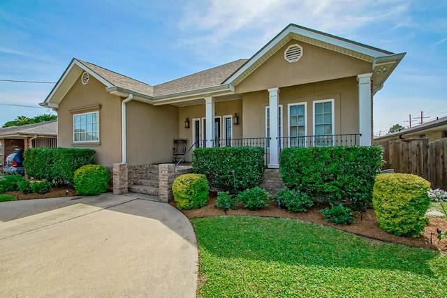 view of front of home featuring stucco siding and covered porch