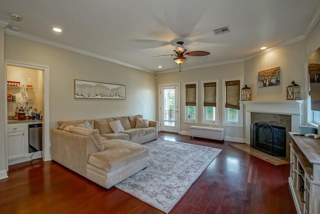 living area featuring ceiling fan, ornamental molding, a high end fireplace, dark wood-type flooring, and recessed lighting