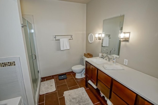 bathroom with tile patterned floors, an enclosed shower, vanity, and toilet
