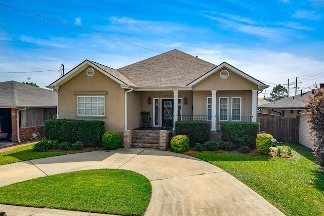 view of front of house featuring stucco siding, covered porch, and a shingled roof