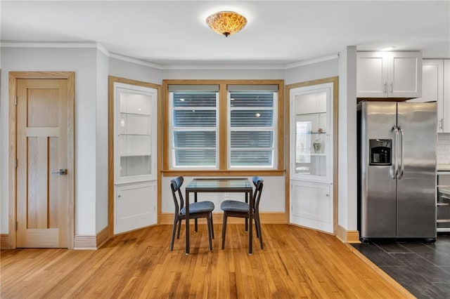 401 Riverdale Dr, Jefferson, LA 70121 - dining space featuring wood finished floors, baseboards, and ornamental molding