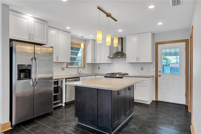 401 Riverdale Dr, Jefferson, LA 70121 - kitchen with stainless steel appliances, wall chimney range hood, white cabinetry, decorative backsplash, and recessed lighting