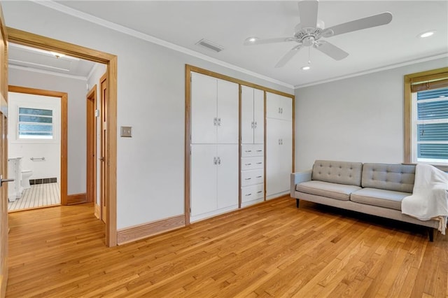 401 Riverdale Dr, Jefferson, LA 70121 - living area featuring light wood-type flooring, ornamental molding, healthy amount of natural light, a ceiling fan, and baseboards