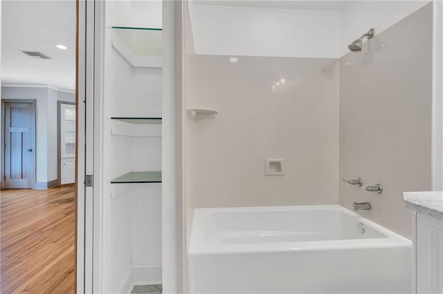 401 Riverdale Dr, Jefferson, LA 70121 - bathroom with tub / shower combination, wood finished floors, ornamental molding, baseboards, and vanity