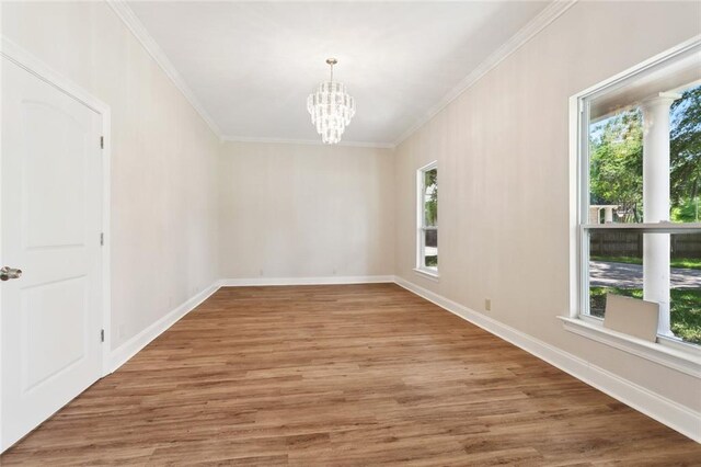 436 Nighthawk Dr, Slidell, LA 70461 - spare room with healthy amount of natural light, a chandelier, crown molding, wood finished floors, and baseboards