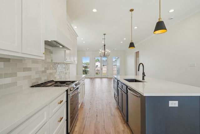 342 W Ave, Harahan, LA 70123 - kitchen with stainless steel appliances, a sink, decorative backsplash, white cabinetry, and recessed lighting