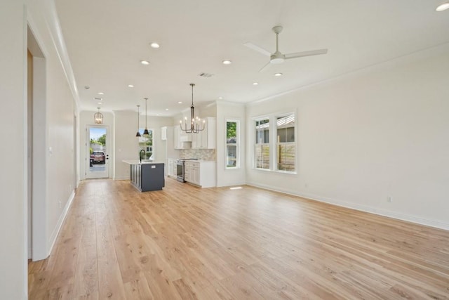 342 W Ave, Harahan, LA 70123 - unfurnished living room featuring crown molding, healthy amount of natural light, recessed lighting, light wood-style flooring, and a ceiling fan