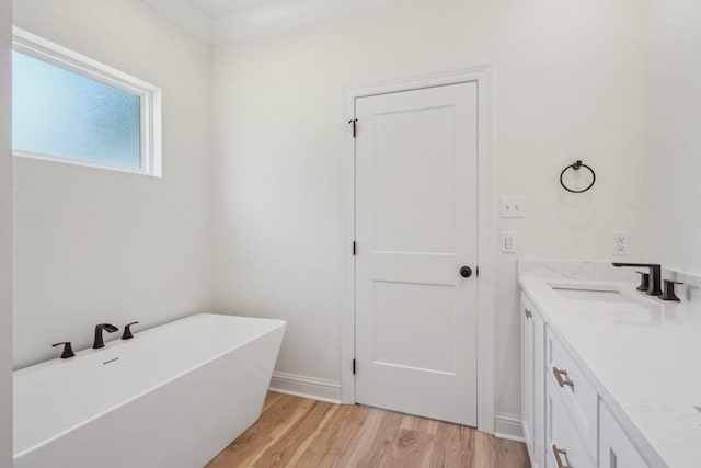 342 W Ave, Harahan, LA 70123 - full bathroom featuring wood finished floors, a freestanding tub, vanity, and baseboards