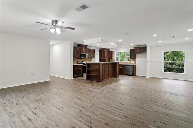 25512 W Spruce St, Lacombe, LA 70445 - kitchen with stainless steel appliances, open floor plan, and recessed lighting