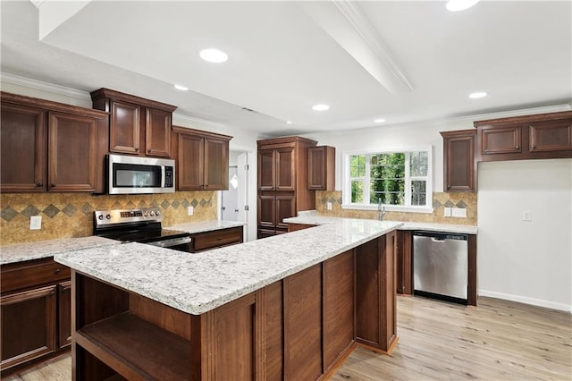 25512 W Spruce St, Lacombe, LA 70445 - kitchen featuring appliances with stainless steel finishes, open shelves, a center island, light wood-style flooring, and backsplash