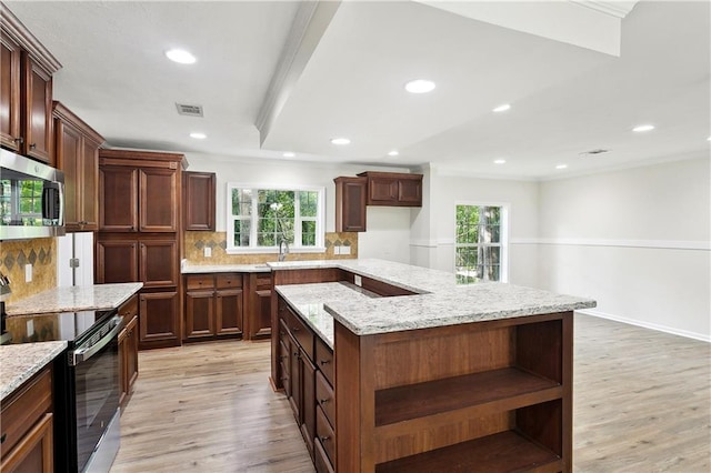 25512 W Spruce St, Lacombe, LA 70445 - kitchen featuring electric stove, stainless steel microwave, open shelves, light wood-style flooring, and tasteful backsplash