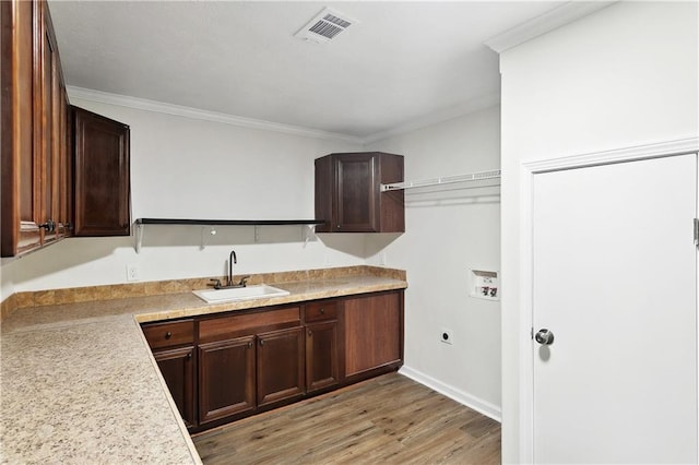 25512 W Spruce St, Lacombe, LA 70445 - washroom featuring washer hookup, crown molding, light wood-style flooring, electric dryer hookup, and baseboards