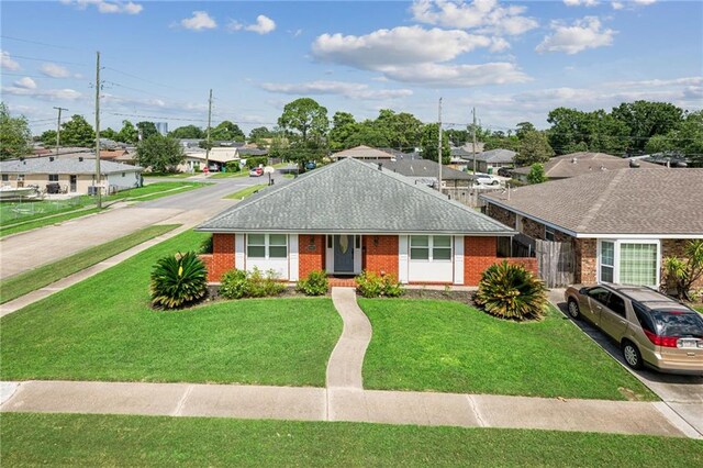 1513 Belmont Pl, Metairie, LA 70001 - ranch-style home with brick siding, a residential view, and a front lawn