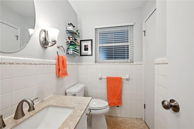 1513 Belmont Pl, Metairie, LA 70001 - bathroom featuring tile walls, toilet, a wainscoted wall, vanity, and speckled floor