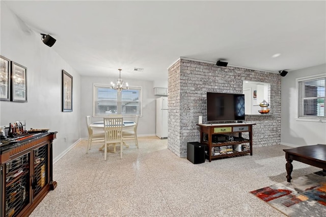 1513 Belmont Pl, Metairie, LA 70001 - living area featuring a chandelier, plenty of natural light, and baseboards