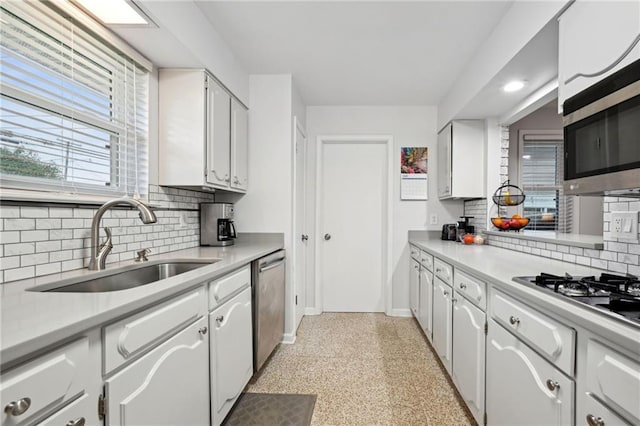 1513 Belmont Pl, Metairie, LA 70001 - kitchen with a sink, stainless steel appliances, baseboards, tasteful backsplash, and dark speckled floor