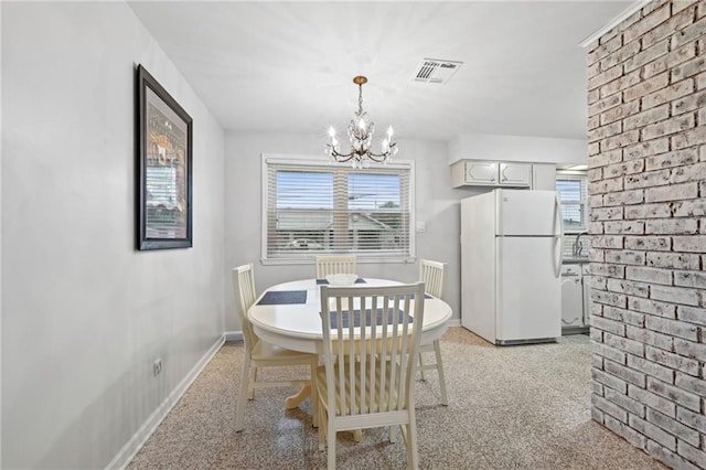 1513 Belmont Pl, Metairie, LA 70001 - dining room featuring a chandelier, plenty of natural light, and baseboards