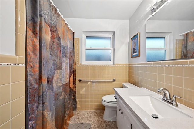 1513 Belmont Pl, Metairie, LA 70001 - full bathroom with tile walls, healthy amount of natural light, toilet, vanity, and a wainscoted wall