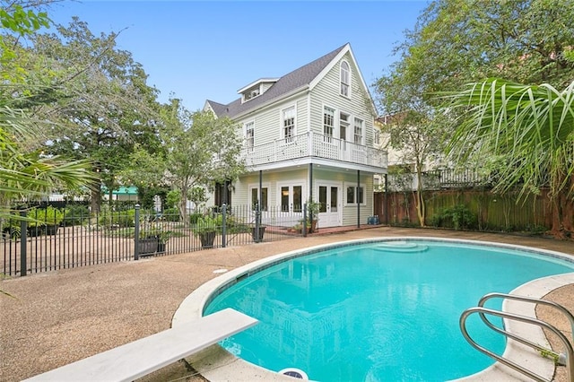 1612 Milan St, New Orleans, LA 70115 - view of swimming pool with french doors, a fenced backyard, a diving board, and a patio area