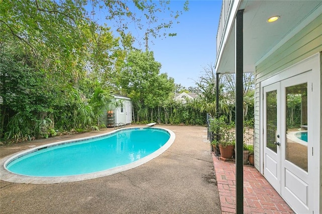 1612 Milan St, New Orleans, LA 70115 - outdoor pool with french doors, a patio, an outdoor structure, and a storage shed