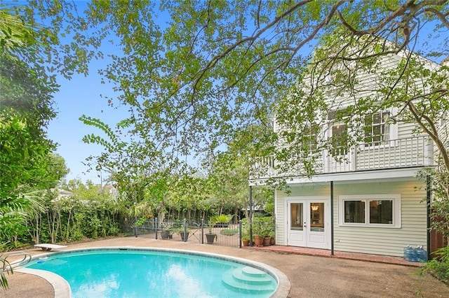 1612 Milan St, New Orleans, LA 70115 - outdoor pool featuring french doors, fence, a diving board, and a patio area