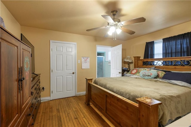 521 S Alexander St, New Orleans, LA 70119 - bedroom with light wood-style flooring, baseboards, and a ceiling fan