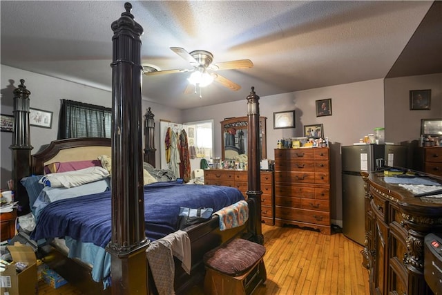 521 S Alexander St, New Orleans, LA 70119 - bedroom with light wood finished floors and a textured ceiling