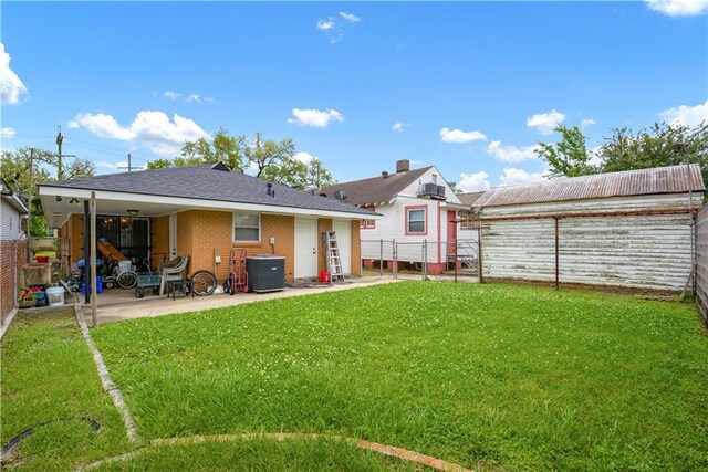 521 S Alexander St, New Orleans, LA 70119 - back of property featuring a patio, brick siding, and central AC