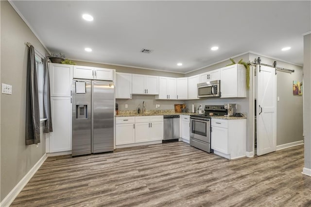 2603 Huey P Long Ave, Gretna, LA 70053 - kitchen with appliances with stainless steel finishes, a barn door, a sink, baseboards, and crown molding
