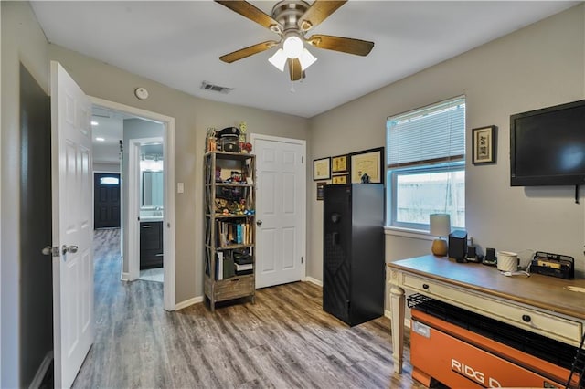 2603 Huey P Long Ave, Gretna, LA 70053 - home office featuring light wood-type flooring, ceiling fan, and baseboards