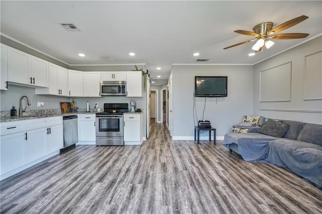 2603 Huey P Long Ave, Gretna, LA 70053 - kitchen with stainless steel appliances, open floor plan, a sink, crown molding, and light stone countertops