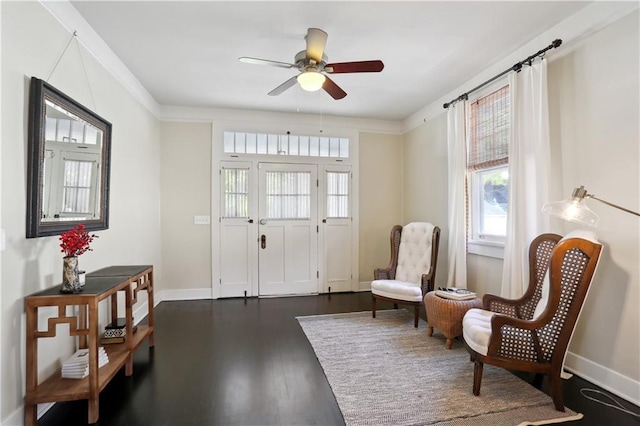 7715 Panola St, New Orleans, LA 70118 - sitting room with healthy amount of natural light, ceiling fan, dark wood finished floors, and baseboards
