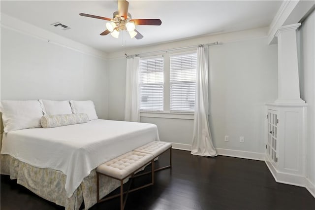 7715 Panola St, New Orleans, LA 70118 - bedroom featuring decorative columns, baseboards, dark wood-style floors, and a ceiling fan