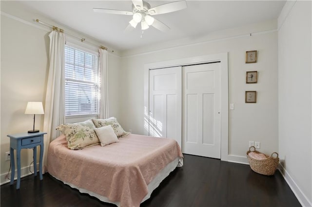 7715 Panola St, New Orleans, LA 70118 - bedroom with dark wood-style floors, a closet, baseboards, and a ceiling fan
