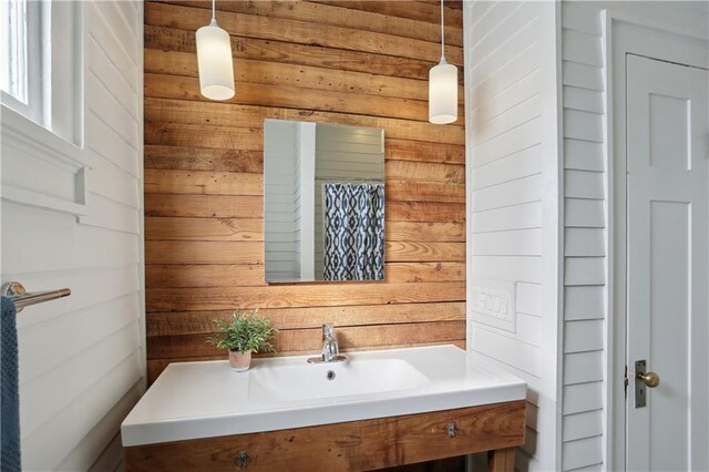 7715 Panola St, New Orleans, LA 70118 - bathroom featuring vanity and wooden walls