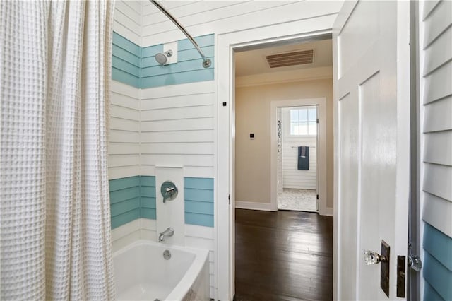 7715 Panola St, New Orleans, LA 70118 - bathroom with shower / bathtub combination with curtain, wood finished floors, baseboards, and crown molding