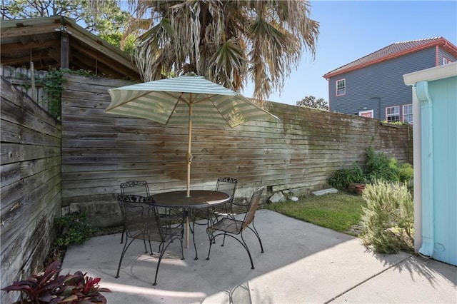 7715 Panola St, New Orleans, LA 70118 - fenced backyard with a patio and outdoor dining area