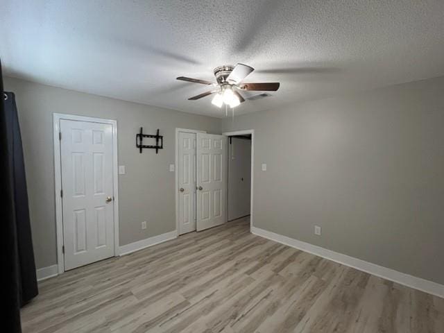 114WCHAMALECOVE W Chamale Cv, Slidell, LA 70460 - unfurnished bedroom featuring light wood finished floors, baseboards, a ceiling fan, and a textured ceiling
