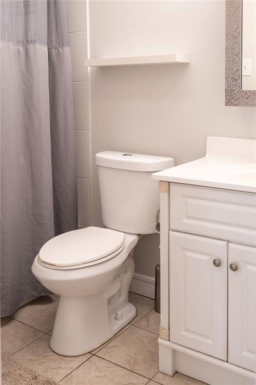114WCHAMALECOVE W Chamale Cv, Slidell, LA 70460 - full bathroom with toilet, vanity, tile patterned flooring, and a shower with curtain