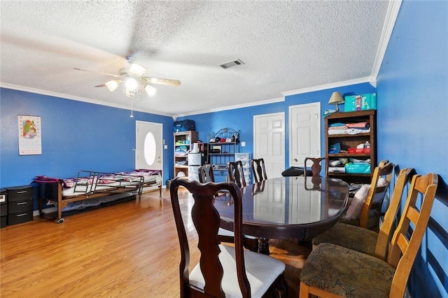 2929 Hudson St, New Orleans, LA 70114 - dining space with a textured ceiling, ornamental molding, ceiling fan, and light wood-type flooring