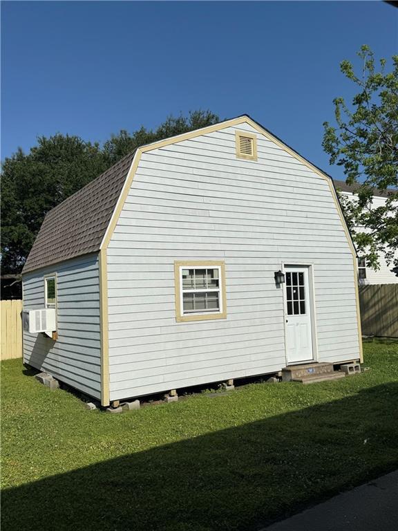 2820 Annette St, New Orleans, LA 70119 - view of side of property with a gambrel roof and a shingled roof