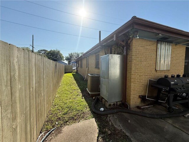 2820 Annette St, New Orleans, LA 70119 - view of property exterior featuring brick siding, cooling unit, and fence