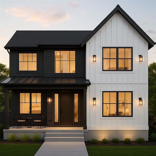 5311 Bancroft Dr, New Orleans, LA 70122 - modern inspired farmhouse with a standing seam roof, a porch, board and batten siding, and metal roof