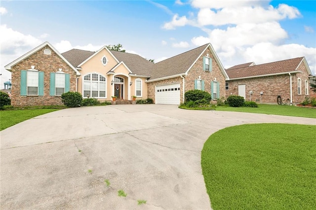 10 Harbor Cv, Slidell, LA 70458 - traditional-style house with driveway, a front lawn, an attached garage, and brick siding